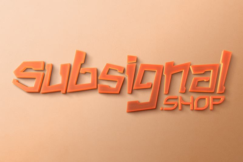 Orange acrylic letters mounted on a peach wall